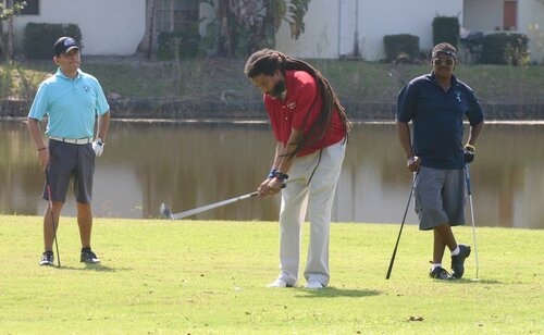 a-long-hair-man-playing-golf