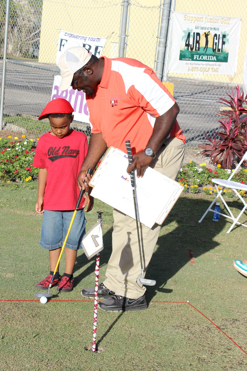 a-man-teaching-golf-to-a-child