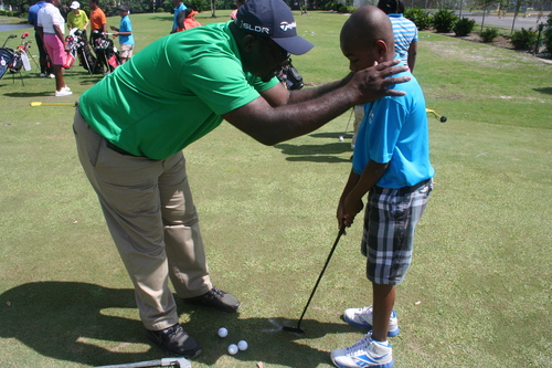 a-man-with-a-boy-teaching-golf