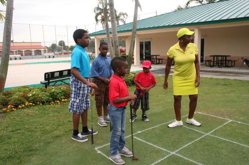 a-women-teaching-golf-to-child-5