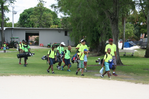 child-practise-golf-in-ground