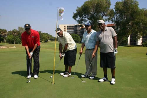 four-men-playing-golf