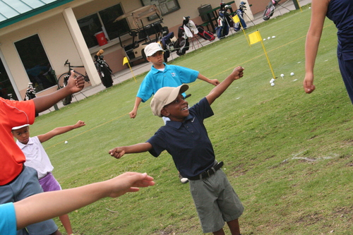 golf-teacher-couching-to-child-2