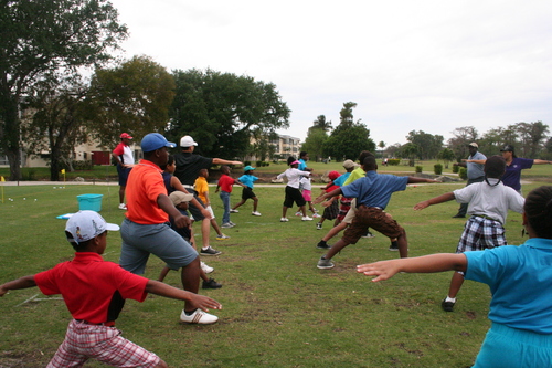 golf-teacher-couching-to-child-4