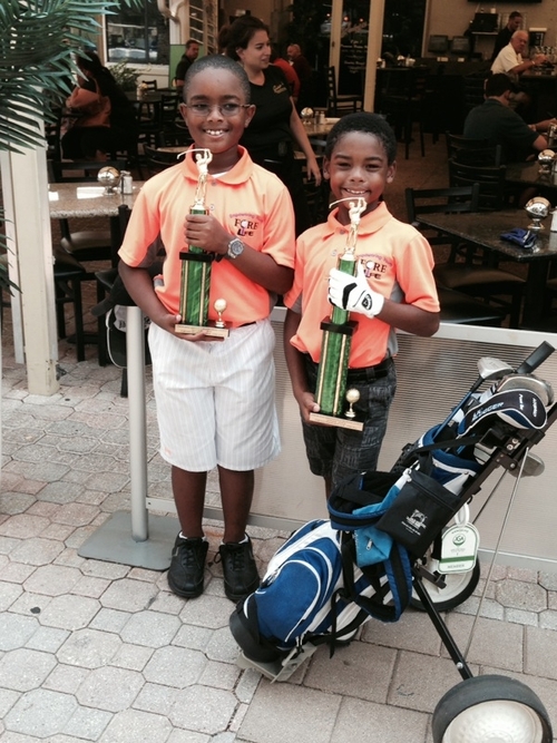 two-golf-player-with-trophy-in-hand