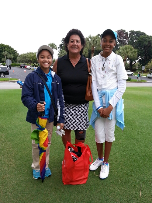 woman-playing-golf-with-two-child